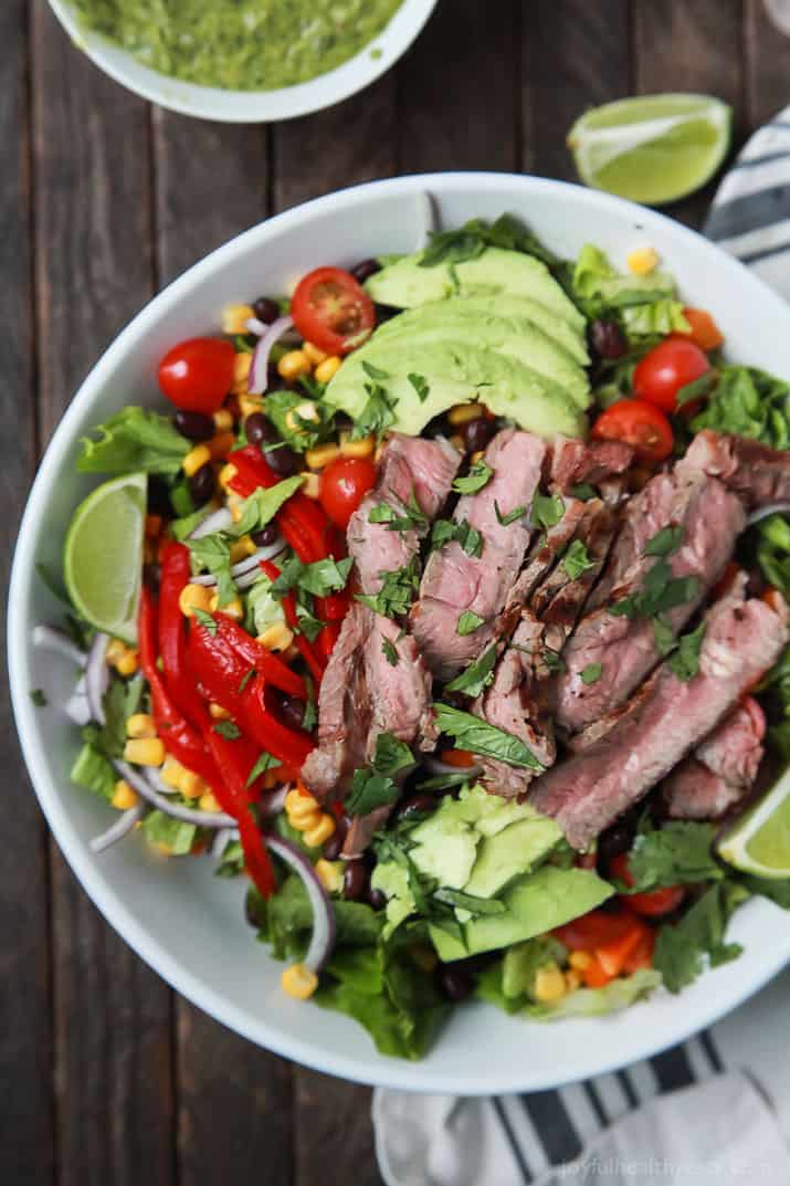 An easy healthy Southwestern Steak Salad loaded with vegetables, tender Ribeye Steak and then topped with a homemade Cilantro Avocado Dressing! Done in 15 minutes, low on calories and rivals any restaurant salad! | joyfulhealthyeats.com #glutenfree