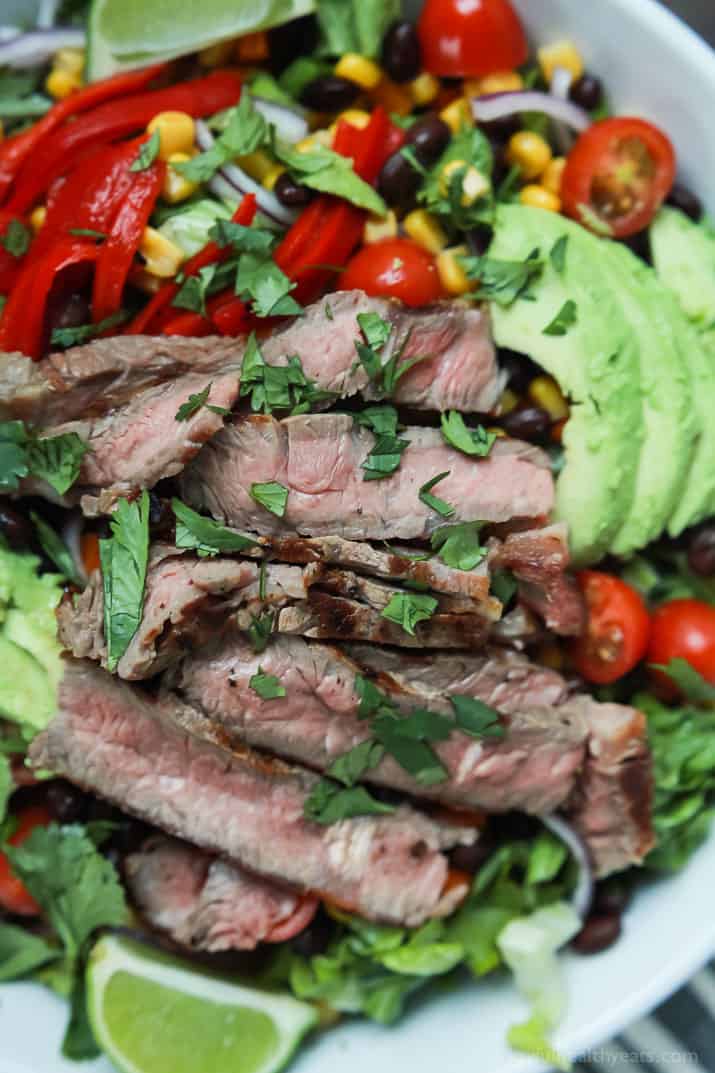 An easy healthy Southwestern Steak Salad loaded with vegetables, tender Ribeye Steak and then topped with a homemade Cilantro Avocado Dressing! Done in 15 minutes, low on calories and rivals any restaurant salad! | joyfulhealthyeats.com #glutenfree