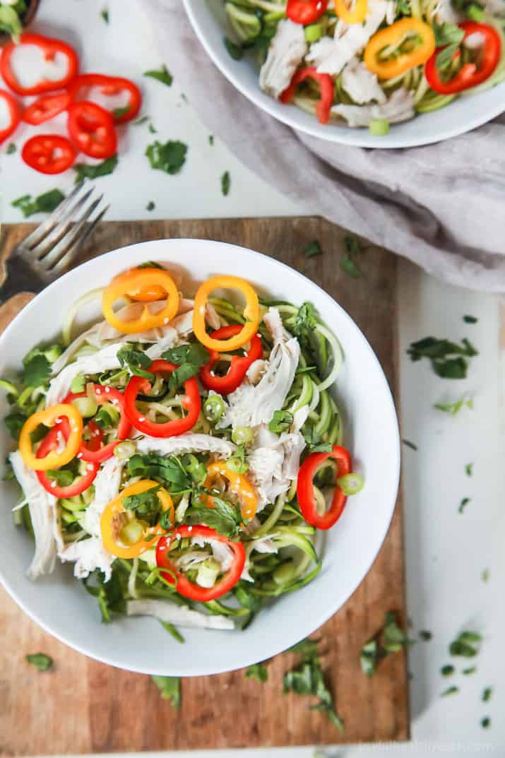 Thai Chicken Zucchini Noodle Salad with a Sesame Vinaigrette done in 15 minutes and only 324 calories. This salad is served cold with raw zucchini noodles, it is refreshing, light, filled with bold flavors and perfect for the summer! | joyfulhealthyeats.com #glutenfree