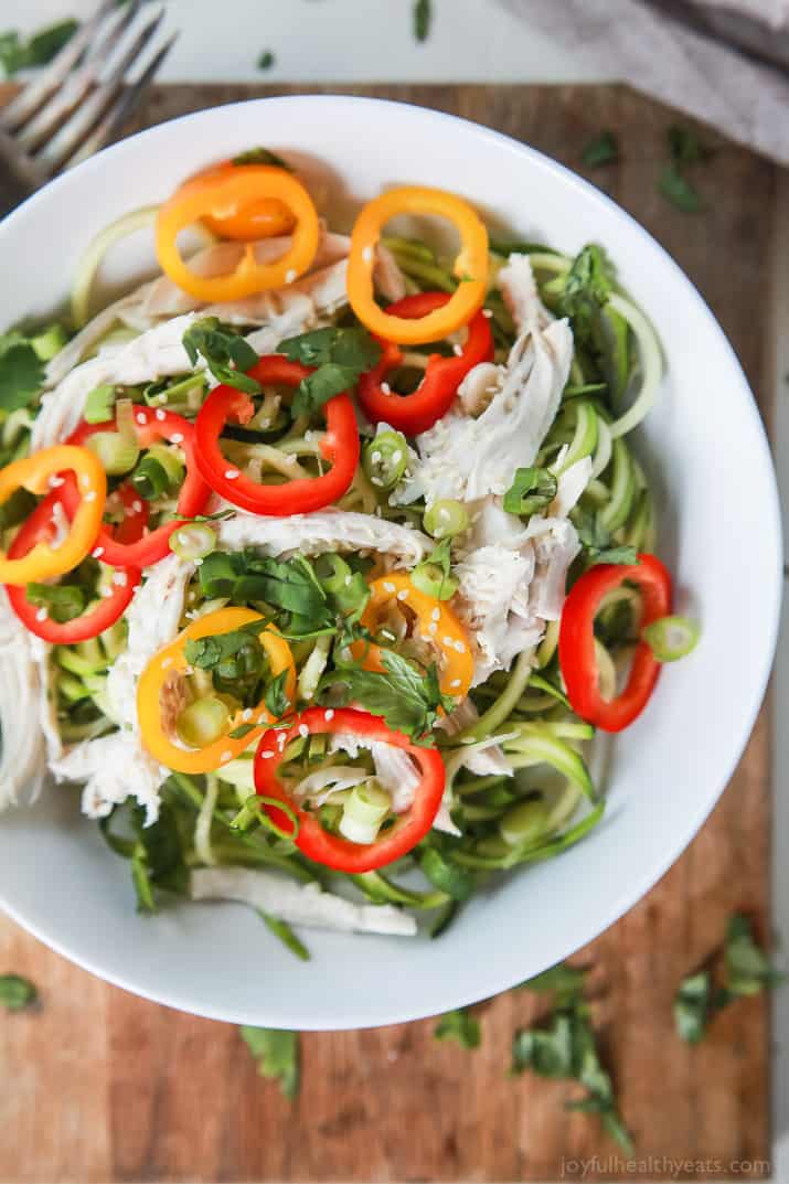 Thai Chicken Zucchini Noodle Salad with a Sesame Vinaigrette done in 15 minutes and only 324 calories. This salad is served cold with raw zucchini noodles, it is refreshing, light, filled with bold flavors and perfect for the summer! | joyfulhealthyeats.com #glutenfree