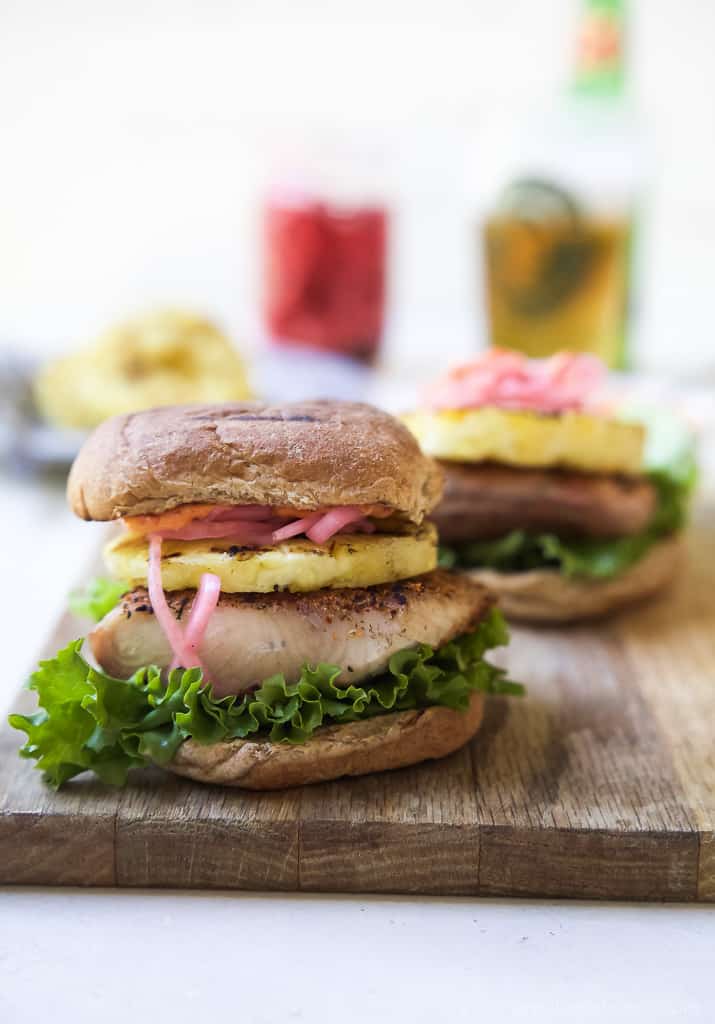 Blackened Mahi Mahi Fish Burger topped with grilled pineapple on a bun