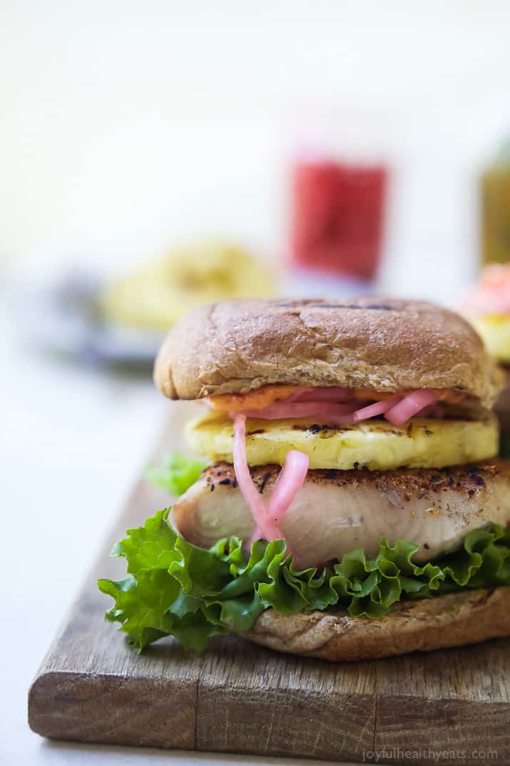 Blackened Mahi Mahi Fish Burger topped with grilled pineapple on a bun