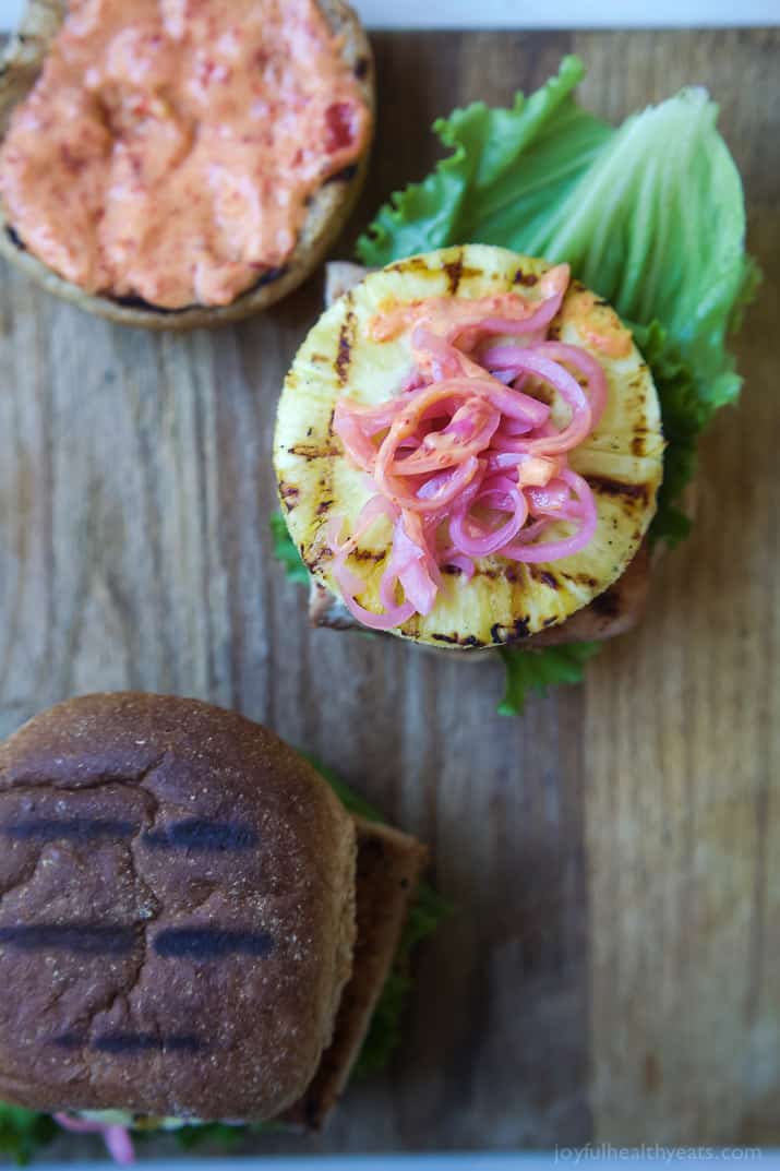 Blackened Mahi Mahi Fish Burger topped with grilled pineapple and pickled onions