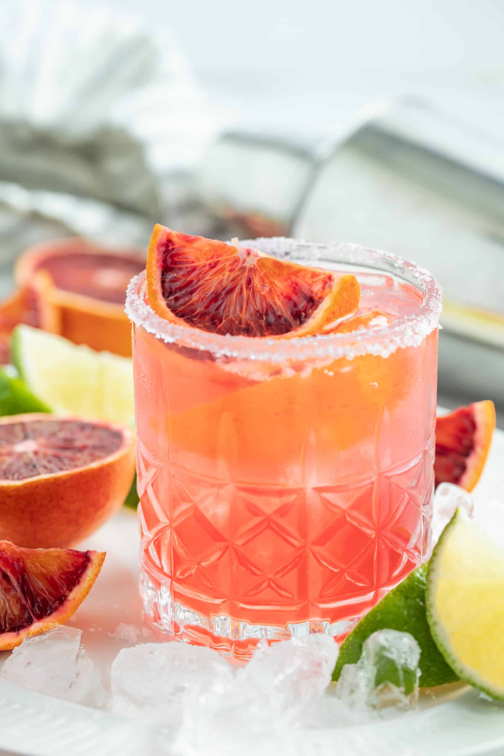 This Fresh Blood Orange Margarita Recipe is festive, citrusy, and flavorful. Plus, it's easy to make and doesn't include simple syrup! an ruby red colored margarita with blood orange garnish