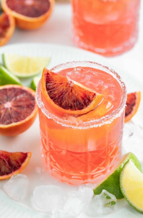 an ruby red colored margarita with blood orange garnish