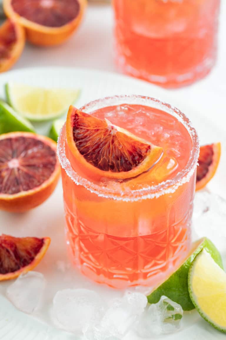 an ruby red colored margarita with blood orange garnish