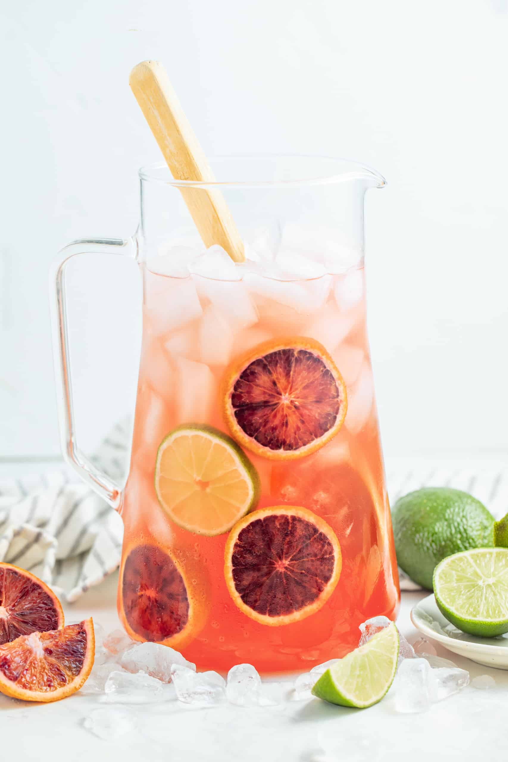 This Fresh Blood Orange Margarita Recipe is festive, citrusy, and flavorful. Plus, it's easy to make and doesn't include simple syrup! It's a wonderful margarita to serve during the holidays with it's deep red hue and big orange flavor. a pitcher of blood orange margaritas