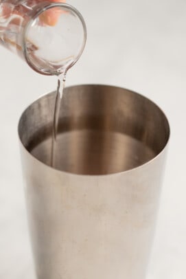 pouring agave into a cocktail shaker