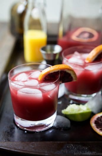 Easy Blood Orange Margaritas with ice and a blood orange slice wedged onto the side of the glass | joyfulhealthyeats.com