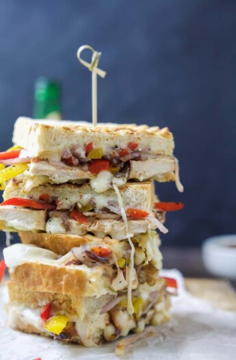 Two slices of Cheesy Chicken Fajita Panini stacked on top.