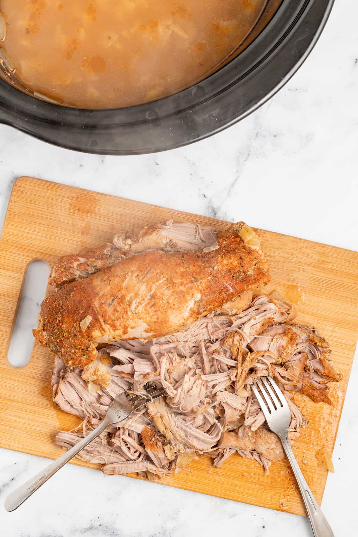 Shredding the pork with two forks. 