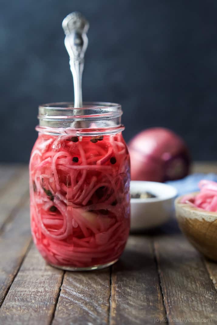 Pickled Onions in a Jar with a utensil
