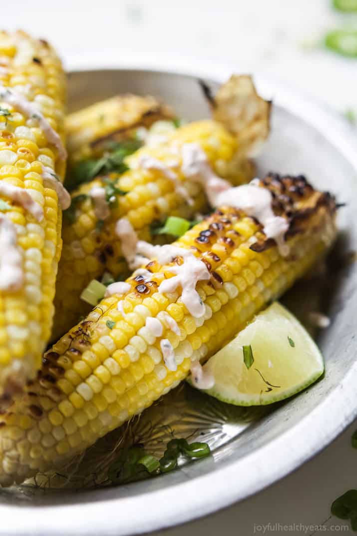 Close-up view of Grilled Corn on the Cob topped with Creamy Roasted Jalapeno Sauce