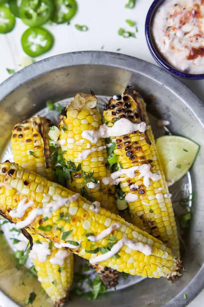 Top view of several ears of Grilled Corn on the Cob topped with Creamy Roasted Jalapano Sauce