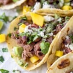 Close-up of street tacos with toppings.