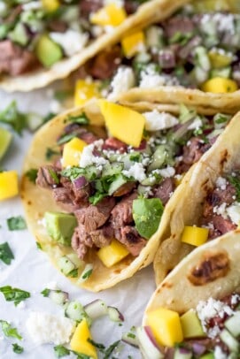 Close-up of street tacos with toppings.