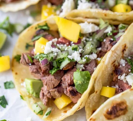 Close-up of street tacos with toppings.