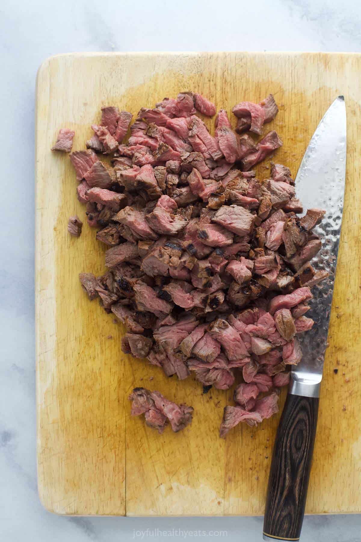 Slicing the filet mignon into smaller pieces.