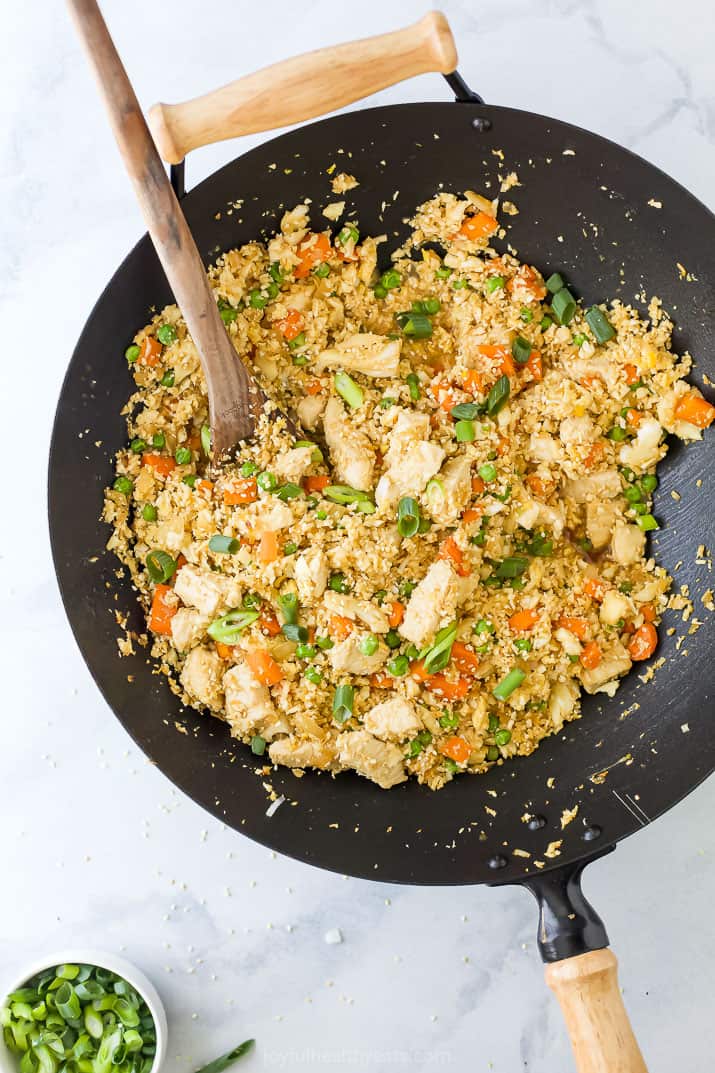 A wok with cauliflower fried rice and chicken