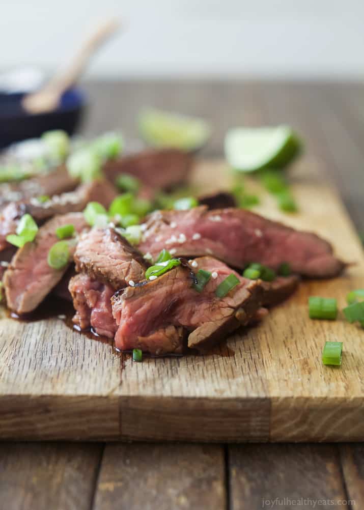 Close up view of sliced Asian Grilled Flank Steak on a cutting board