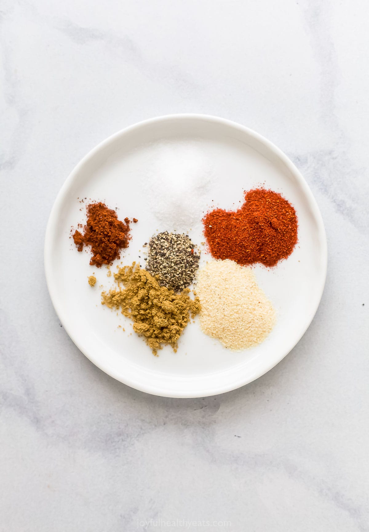Spices for the spice mix in a plate. 