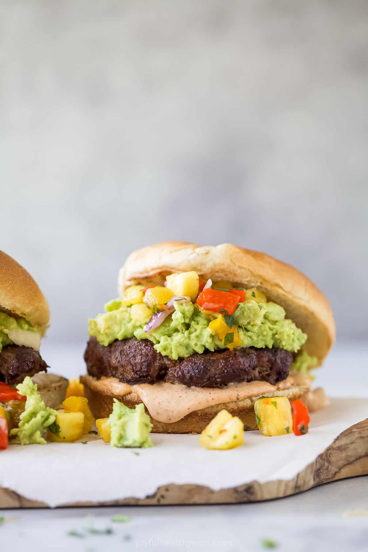 Avocado burger with the top bun on the side. 