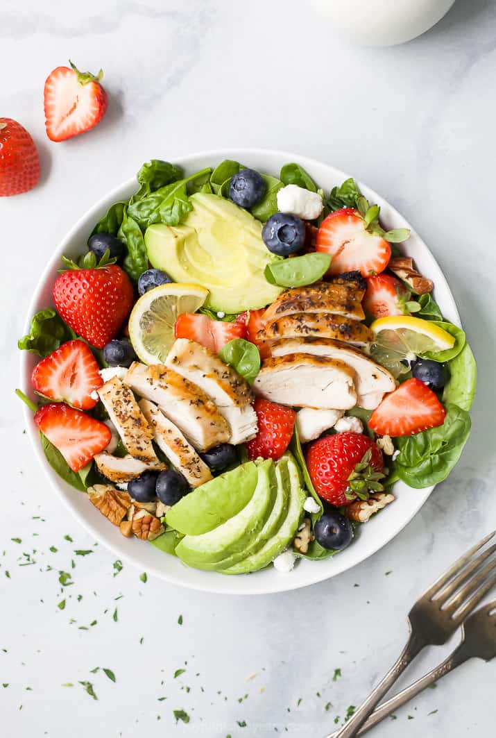 overhead photo of best avocado strawberry spinach salad with grilled chicken