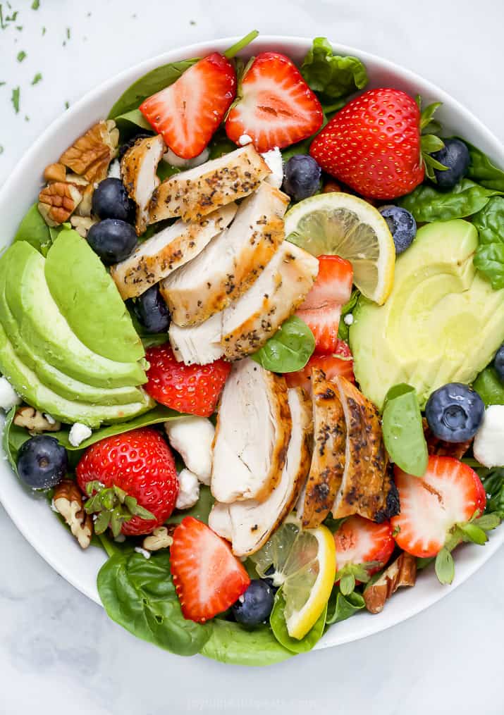 closeup of best avocado strawberry salad with grilled chicken