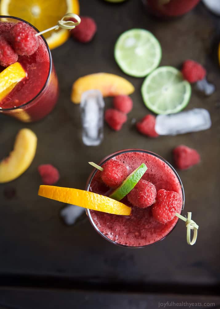 Top view of glasses of Frozen Raspberry Peach Sangria garnished with fruit