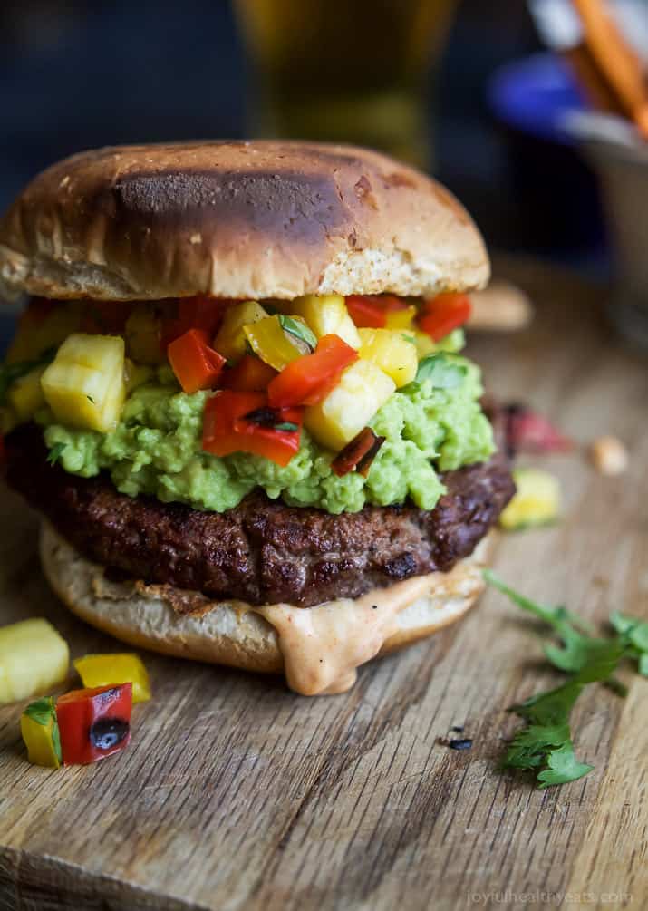 Smoky Avocado Burgers topped with a Pineapple Pepper Relish! These burgers don't run short on flavor, they are juicy, tender, mouthwatering basically everything you want in a Burger + more! | joyfulhealthyeats.com