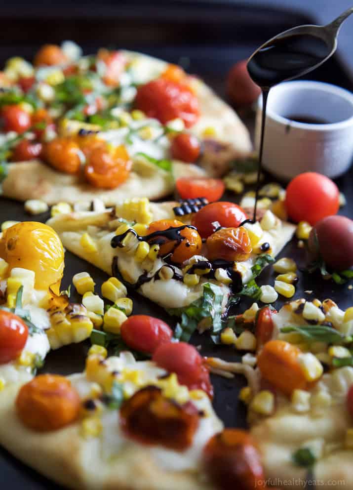 An easy delicious Charred Corn Caprese Flatbread topped with sweet Balsamic Reduction - it screams summer, takes 30 minutes to make, and uses less than 10 ingredients! You're gonna love it! | joyfulhealthyeats.com