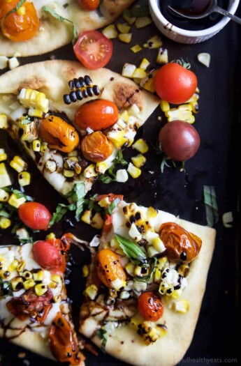 An easy delicious Charred Corn Caprese Flatbread topped with sweet Balsamic Reduction - it screams summer, takes 30 minutes to make, and uses less than 10 ingredients! You're gonna love it! | joyfulhealthyeats.com