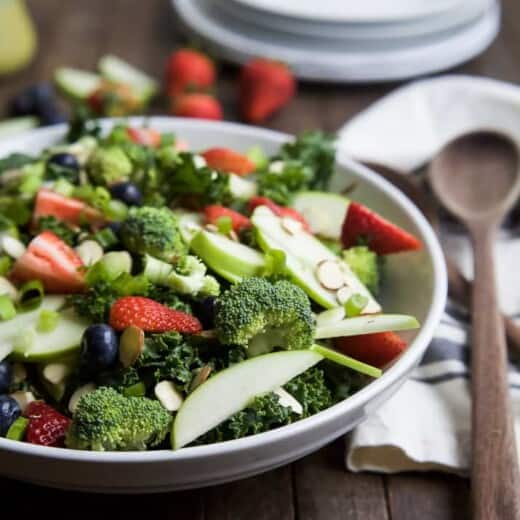 Image of a Detox Summer Salad with Citrus Basil Vinaigrette on a Plate with a Wooden Spoon