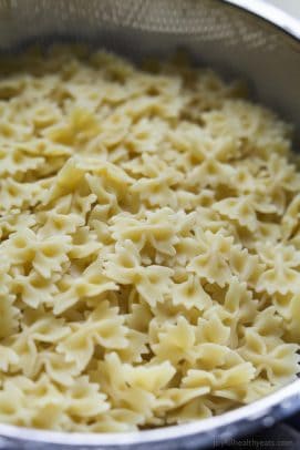 Cooked bowtie pasta in a colander.