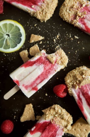 Lemon Raspberry Cheesecake Popsicles, creamy, lemony and filled with fresh fruit. The perfect refreshing treat to cool you down this summer, they taste just like biting into a real cheesecake except half the calories! | joyfulhealthyeats.com