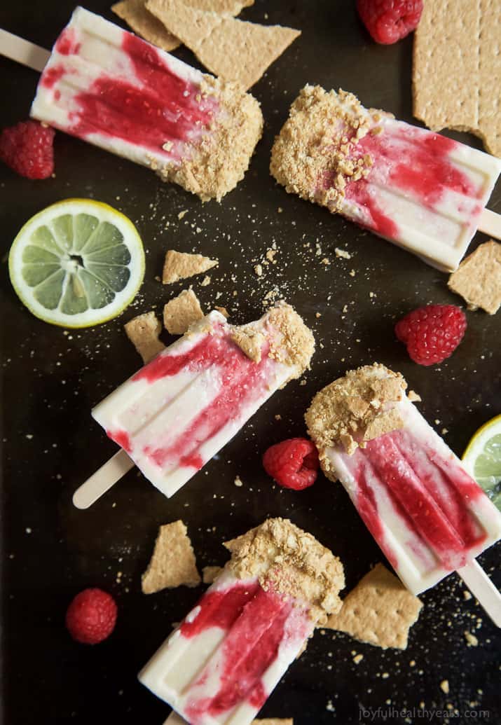 Lemon Raspberry Cheesecake Popsicles, creamy, lemony and filled with fresh fruit. The perfect refreshing treat to cool you down this summer, they taste just like biting into a real cheesecake except half the calories! | joyfulhealthyeats.com 