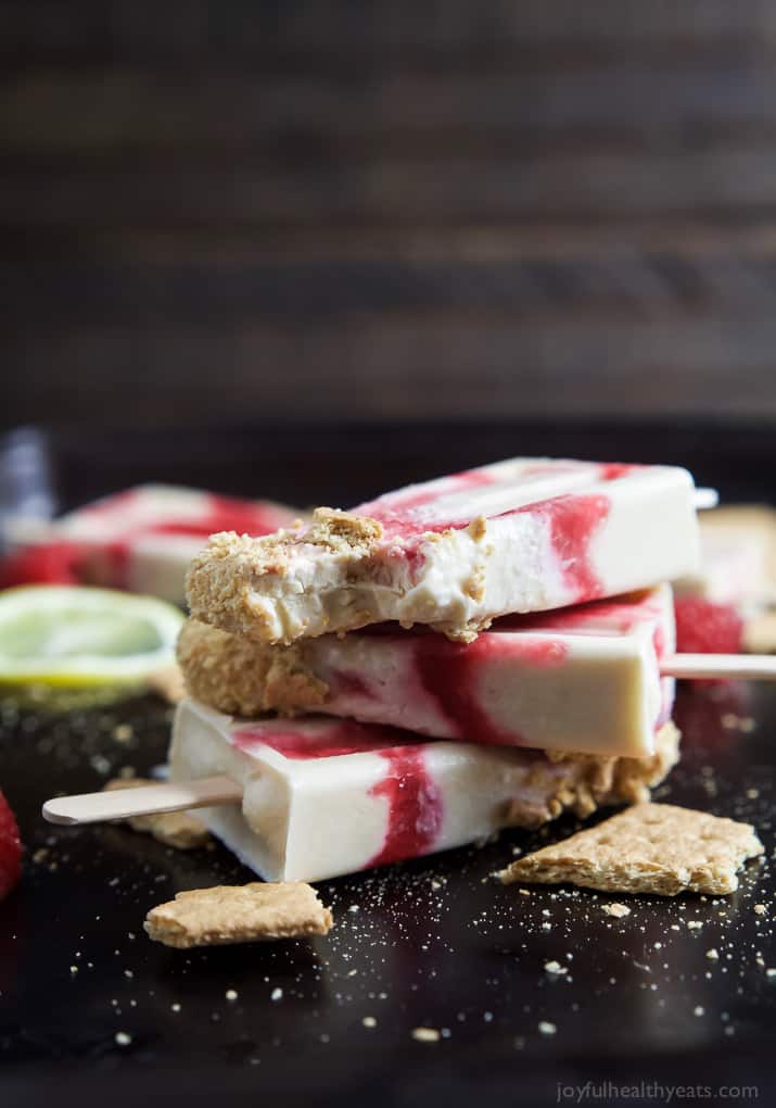 Lemon Raspberry Cheesecake Popsicles, creamy, lemony and filled with fresh fruit. The perfect refreshing treat to cool you down this summer, they taste just like biting into a real cheesecake except half the calories! | joyfulhealthyeats.com 