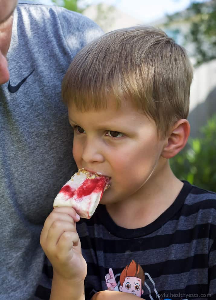 Lemon Raspberry Cheesecake Popsicles, creamy, lemony and filled with fresh fruit. The perfect refreshing treat to cool you down this summer, they taste just like biting into a real cheesecake except half the calories! | joyfulhealthyeats.com 