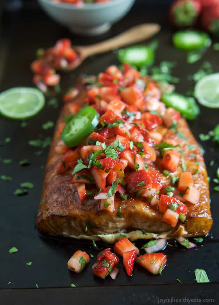 Spice Rubbed Cedar Plank Salmon topped with a refreshing Strawberry Salsa. This Salmon is the ultimate summer main dish and definitely a crowd pleaser! | joyfulhealthyeats.com #glutenfree