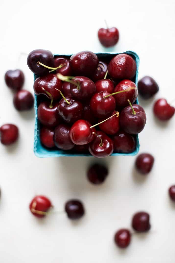 Top view of a pint of fresh cherries