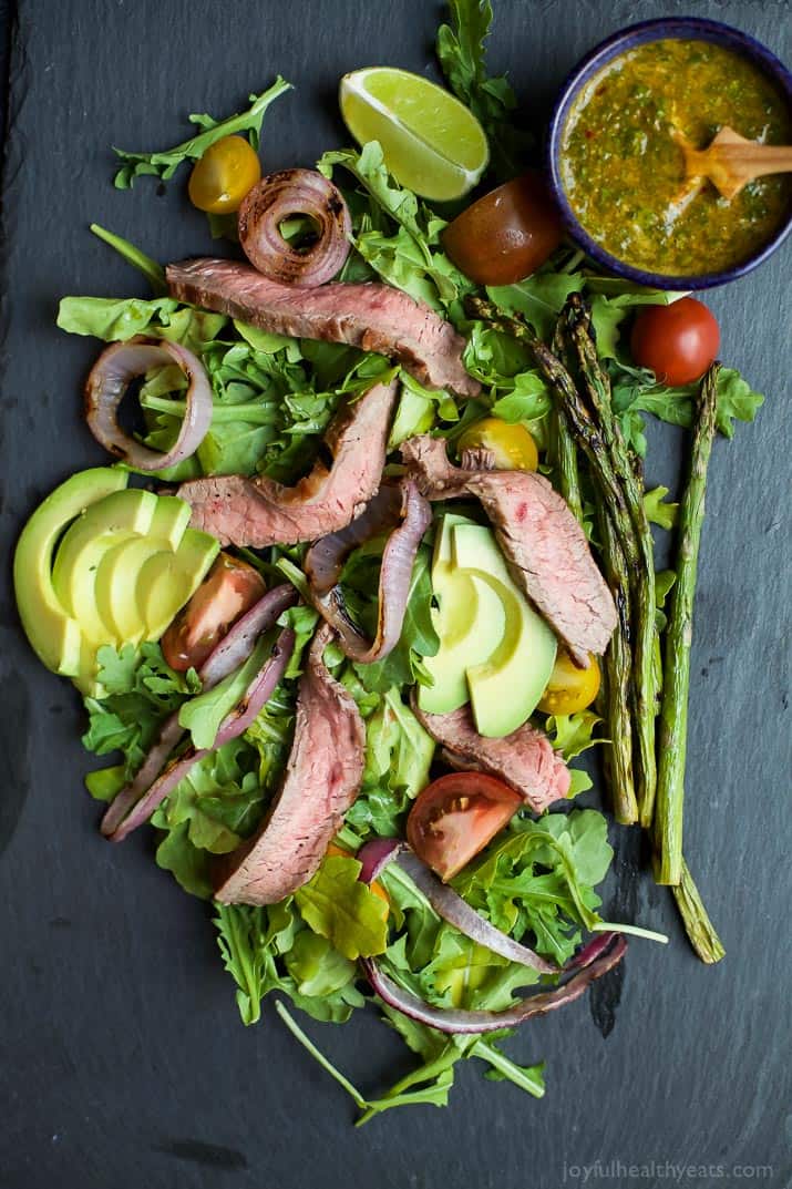 Top view of California Steak Salad with sliced avocado and Chimichurri Dressing