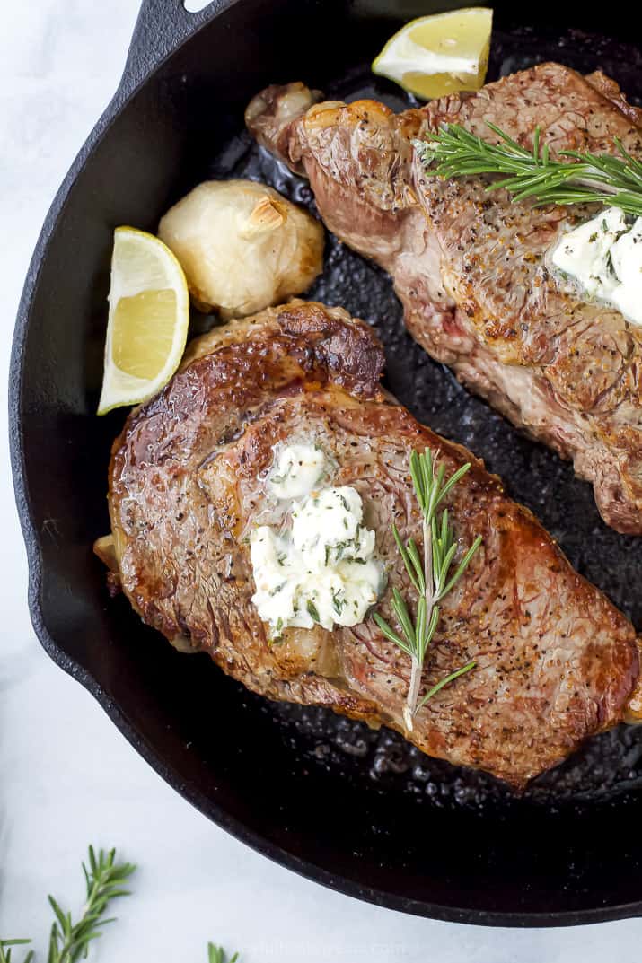 ribeye in skillet with butter on top