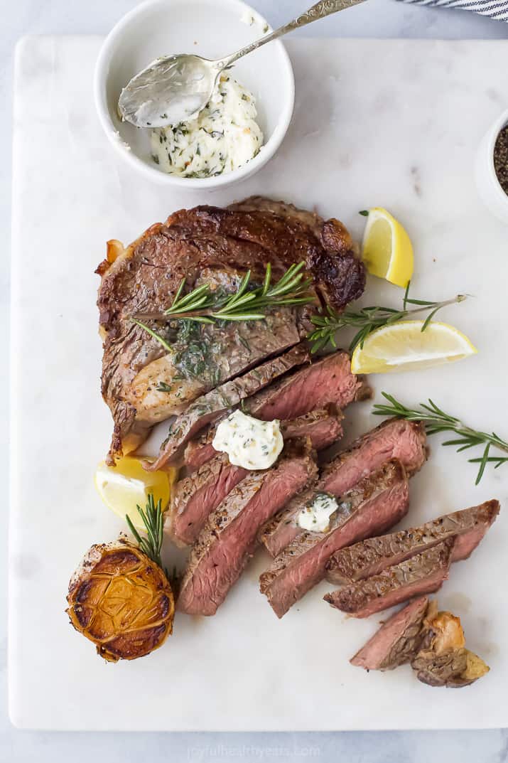 sliced ribeye with herb butter on top