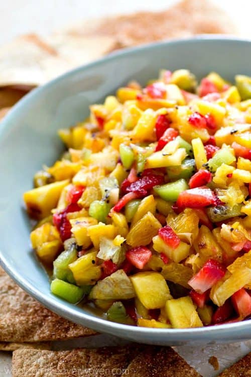 Fresh pineapple gets grilled to sweet ‘n’ smoky perfection and then tossed with fresh kiwi, strawberries, and orange for one killer summer fruit salsa!—Don’t forget the cinnamon tortilla chips!