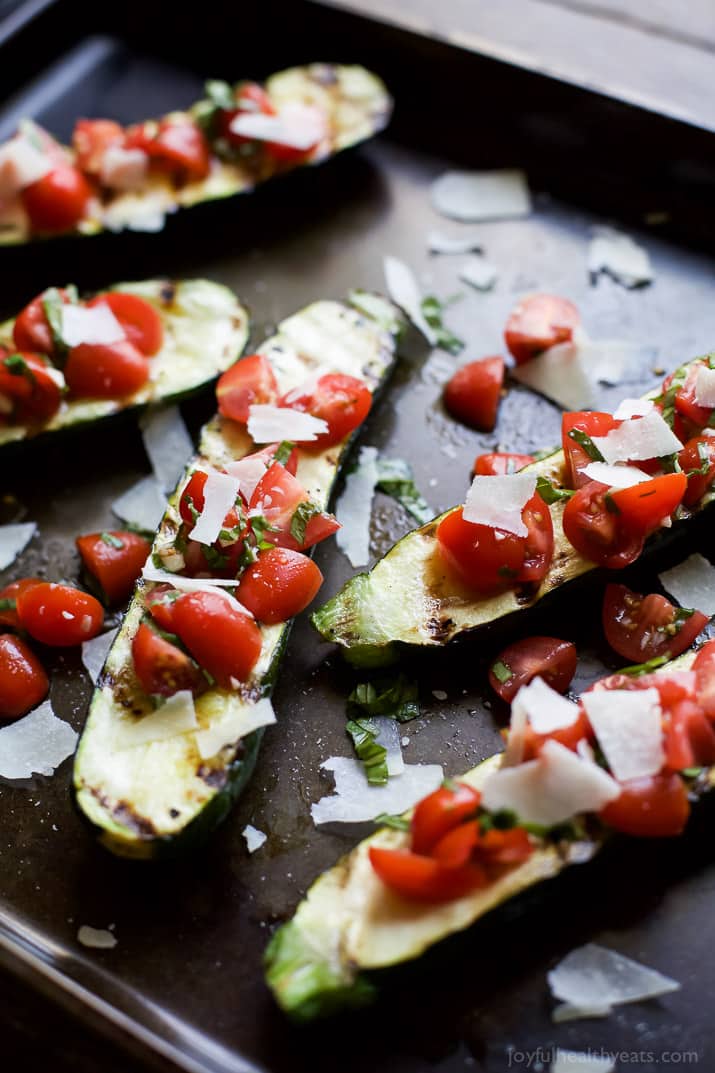 Grilled Zucchini topped with fresh Tomato Basil Bruschetta and Parmesan on a sheet pan