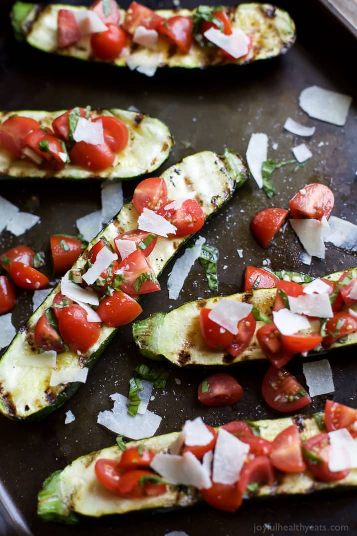 Top view of Grilled Zucchini topped with fresh Tomato Basil Bruschetta and Parmesan