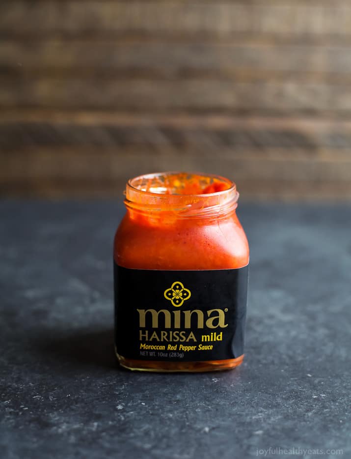 A Jar of Mild Harissa on a Black and White Speckled Countertop