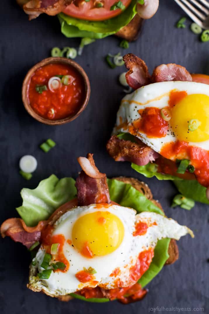 A Bird's-Eye View of Open Faced BLT Breakfast Sandwiches on a Black Surface
