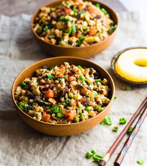 Two Wooden Bowls Containing Paleo Cauliflower Fried Rice