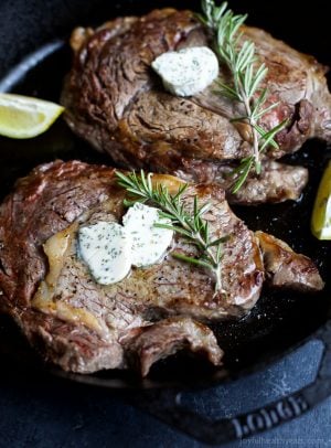 pan seared ribeye in a skillet with herb butter